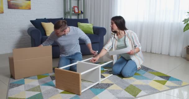 Young Couple Assembling Furniture Home — Stock Video