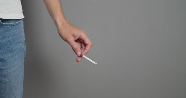 Young Man Smoking Cigarette Grey Background — Stock Video