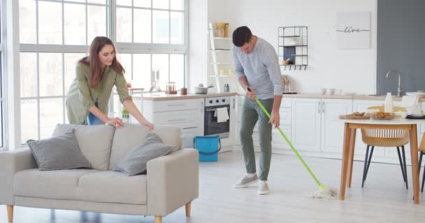 Young Couple Cleaning House Together — Stock Video