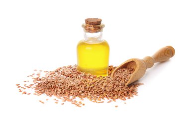 Beyaz arka planda keten yağı ve tohum şişesi