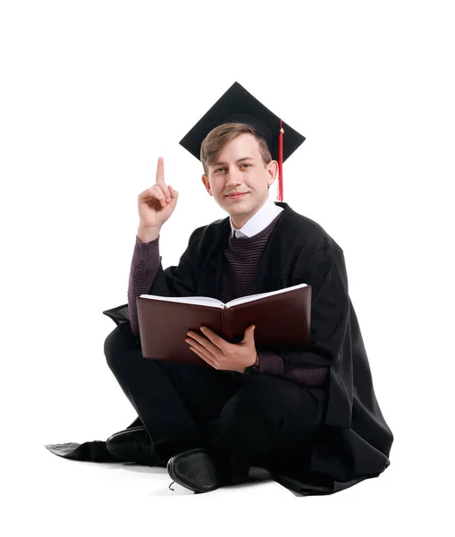 Male Graduating Student Book Raised Index Finger White Background — Stock Photo, Image