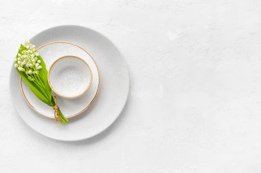 Vadideki güzel zambak çiçekleri ve açık arkaplanda tabaklar