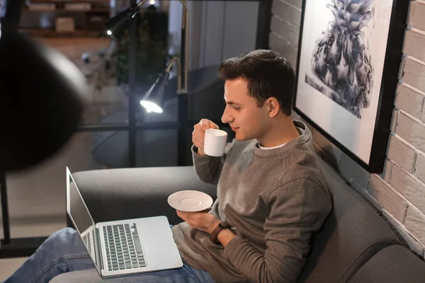 Handsome Man Drinking Coffee While Using Laptop Home Late Evening — Stock Photo, Image