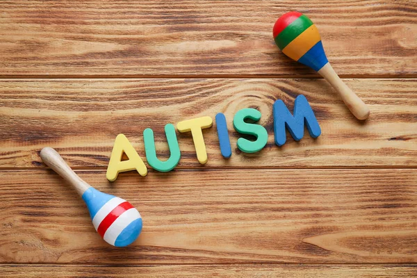 Word Autism Maracas Wooden Background — Stock Photo, Image