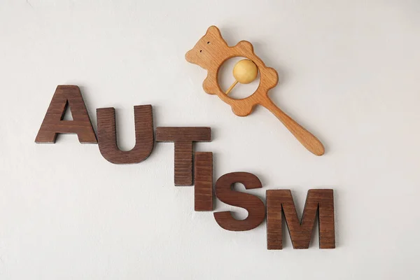 Word Autism Rattle Light Background — Stock Photo, Image