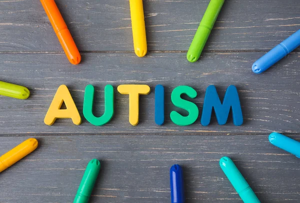 Word Autism Chalks Dark Wooden Background — Stock Photo, Image