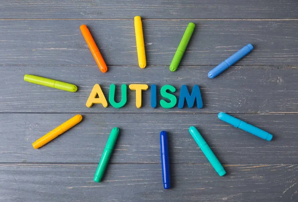 Word Autism Chalks Dark Wooden Background — Stock Photo, Image