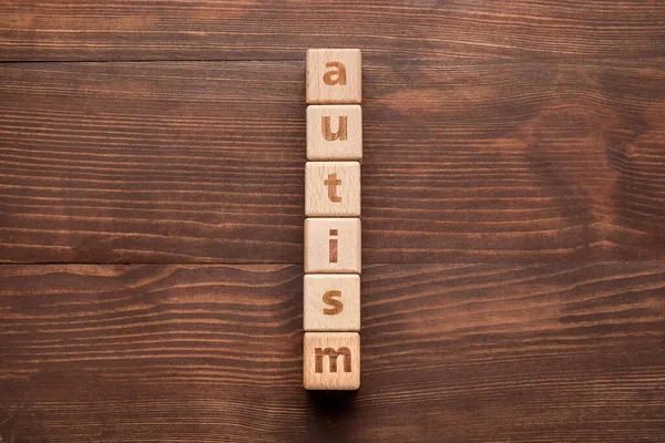 Word Autism Made Cubes Dark Wooden Background — Stock Photo, Image