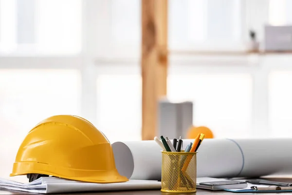 Hardhat of engineer on table in office