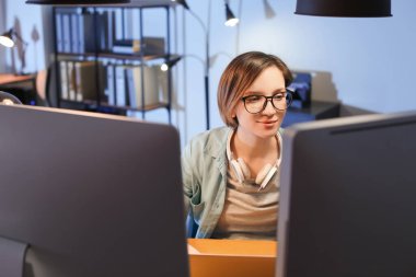Geceleri ofiste çalışan kadın programcı.
