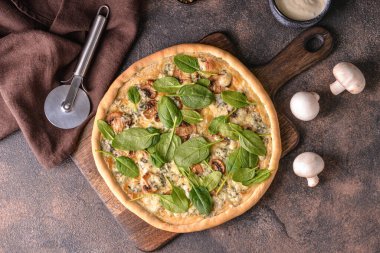 Arkaplanda ıspanaklı lezzetli vejetaryen pizza.