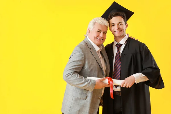 Happy Male Graduation Student His Father Color Background — Stock Photo, Image
