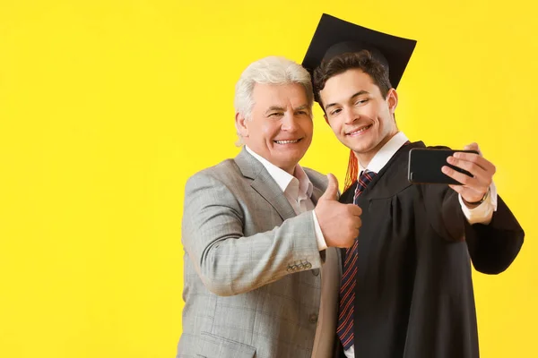 Happy Male Graduation Student His Father Taking Selfie Color Background — Stock Photo, Image