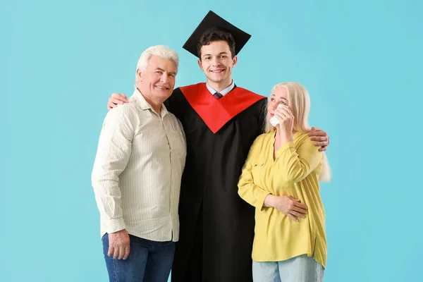 Happy Male Graduation Student His Parents Color Background — Stock Photo, Image