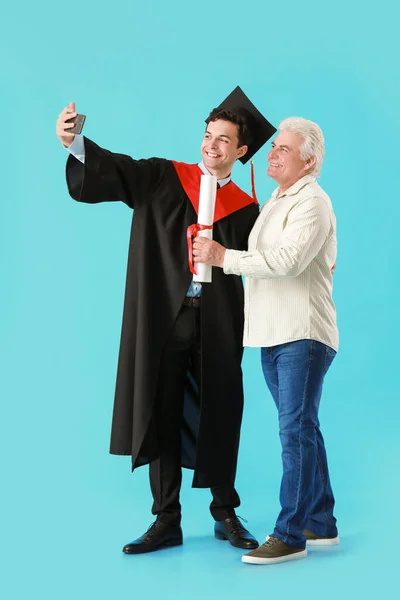 Happy Male Graduation Student His Father Taking Selfie Color Background — Stock Photo, Image