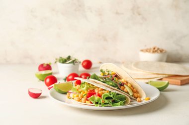 Hafif arka planda lezzetli vejetaryen taco tabağı.