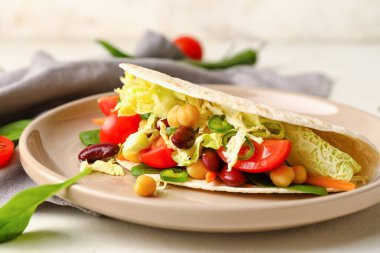 Hafif arka planda lezzetli vejetaryen taco tabağı, yakın plan.