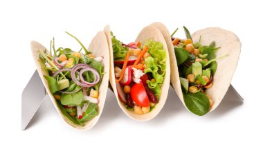 Stand with tasty vegetarian tacos on white background clipart