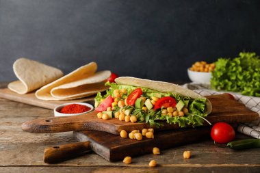 Karanlık arka planda lezzetli vejetaryen tacolu tahtalar.