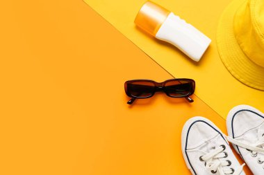 Güneş kremi, ayakkabı ve şapkalı şık güneş gözlükleri.