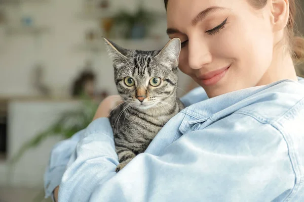 stock image Beautiful young woman with cute cat at home, closeup