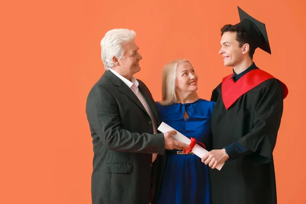 Happy Male Graduation Student His Parents Color Background — Stock Photo, Image