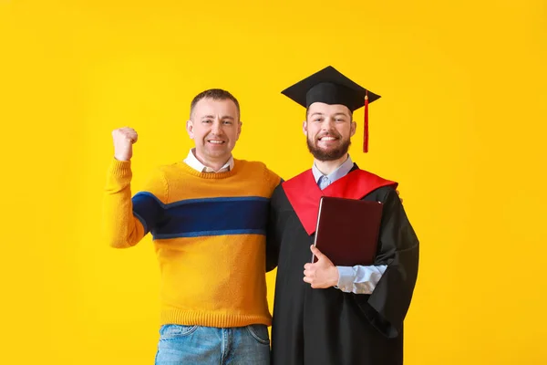 Happy Male Graduation Student His Father Color Background — Stock Photo, Image
