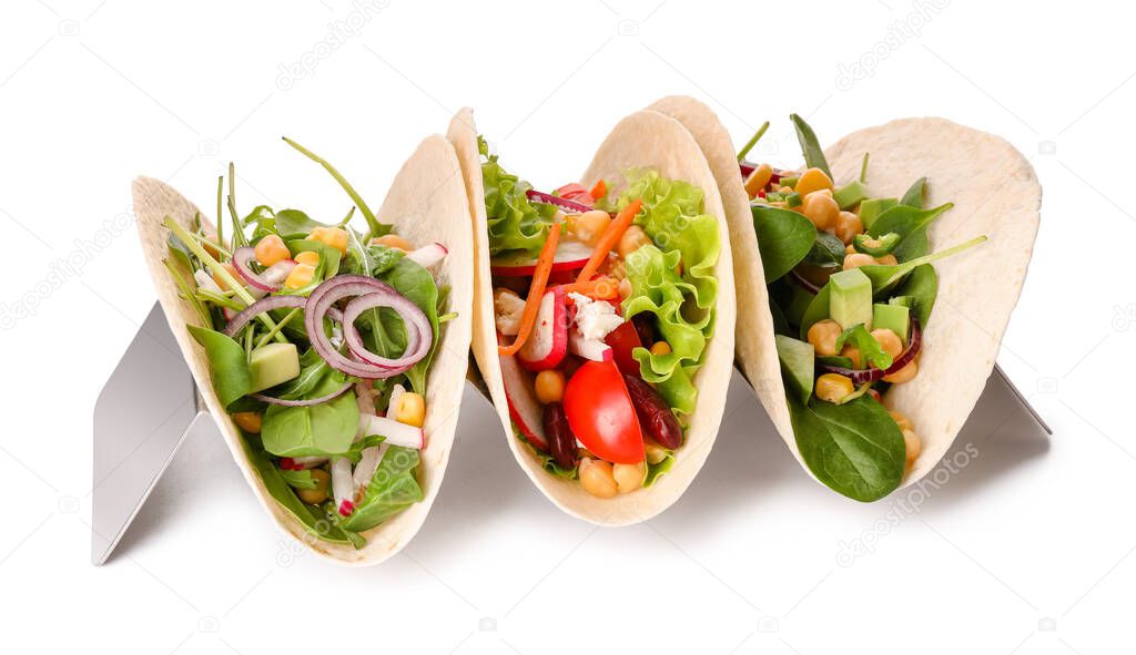 Stand with tasty vegetarian tacos on white background