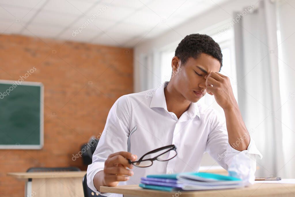 African-American student passing difficult exam at school