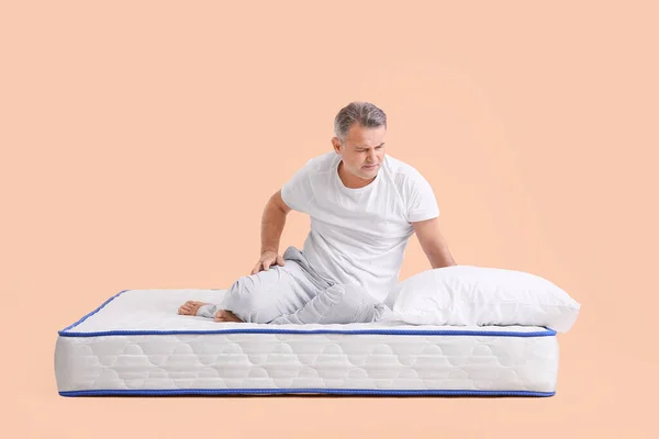 Mature Man Suffering Pain Mattress Color Background — Stock Photo, Image