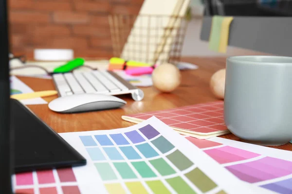 Color swatches at workplace of graphic designer in office
