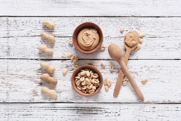 Bowls Tasty Peanut Butter Nuts Table — Stock Photo, Image