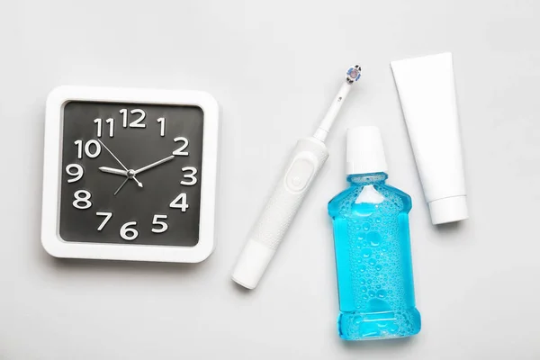 stock image Composition with stylish clock and tooth brush on light background