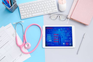 Steteskoplu tablet bilgisayar, sigorta formu ve doktor aksesuarları.