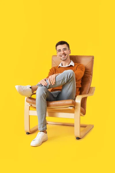 Young Man Sitting Armchair Color Background — Stock Photo, Image