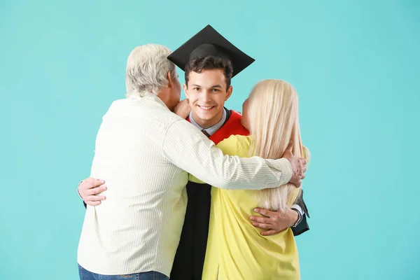 Happy Male Graduation Student His Parents Color Background — Stock Photo, Image