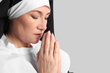 Gri arka planda olgun bir rahibe