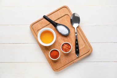 Açık ahşap zemin üzerinde bal ve baharat bulunan tahta