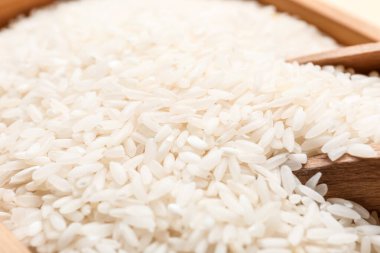 Çiğ pirinç ve kepçe ile kutu, yakın plan.