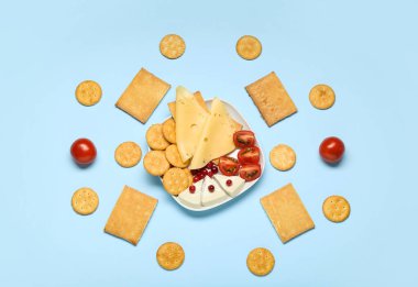 Renkli arka planda lezzetli kraker ve abur cubur tabağı