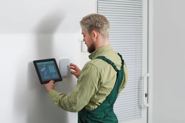 Worker Tablet Computer Checking Alarm System Indoors — Stock Photo, Image