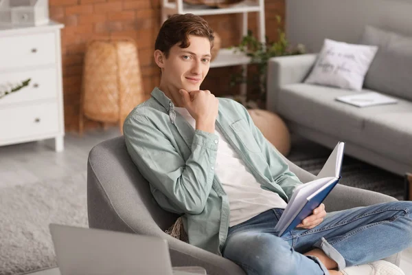 Joven Leyendo Libro Mientras Está Sentado Sillón Casa —  Fotos de Stock