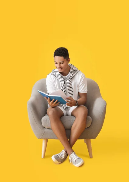 Young African American Guy Reading Book While Sitting Armchair Color — Stock Photo, Image