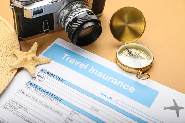 Composition with travel insurance and compass on color background, closeup