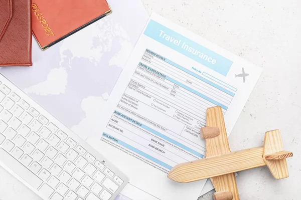 Composition with travel insurance and wooden plane on white background