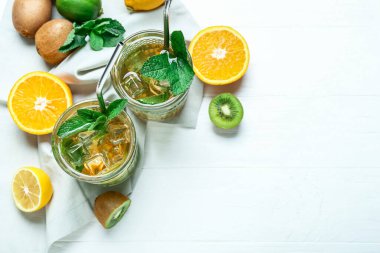 Hafif arka planda kivi ve limonlu lezzetli buzlu çay.