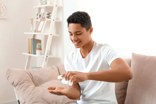 African American Teenage Boy Taking Fish Oil Pill Home — Stock Photo, Image