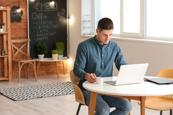 Guapo Joven Bebiendo Café Mientras Trabaja Con Ordenador Portátil Cafetería — Foto de Stock