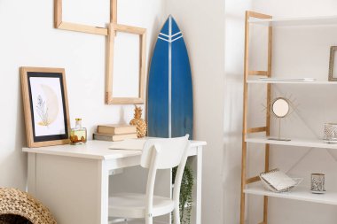 Modern iş yeri ve sörf tahtası şık bir odanın içinde.