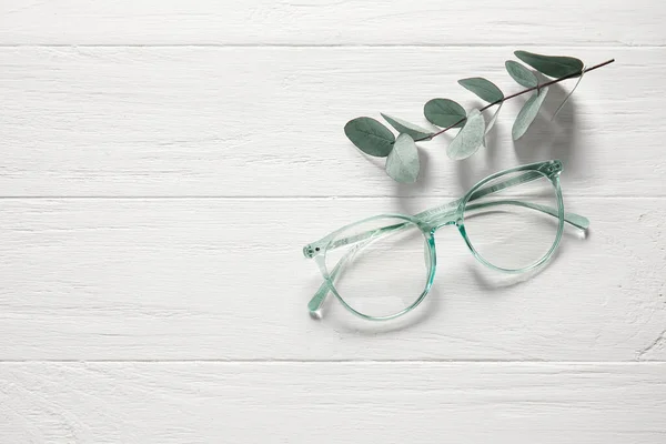 Óculos Elegantes Ramo Eucalipto Fundo Madeira Branca — Fotografia de Stock